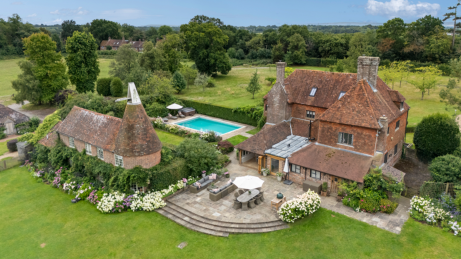 Palehouse Farm Uckfield East Sussex: aerial shot of the property featuring a swimming pool and oast house