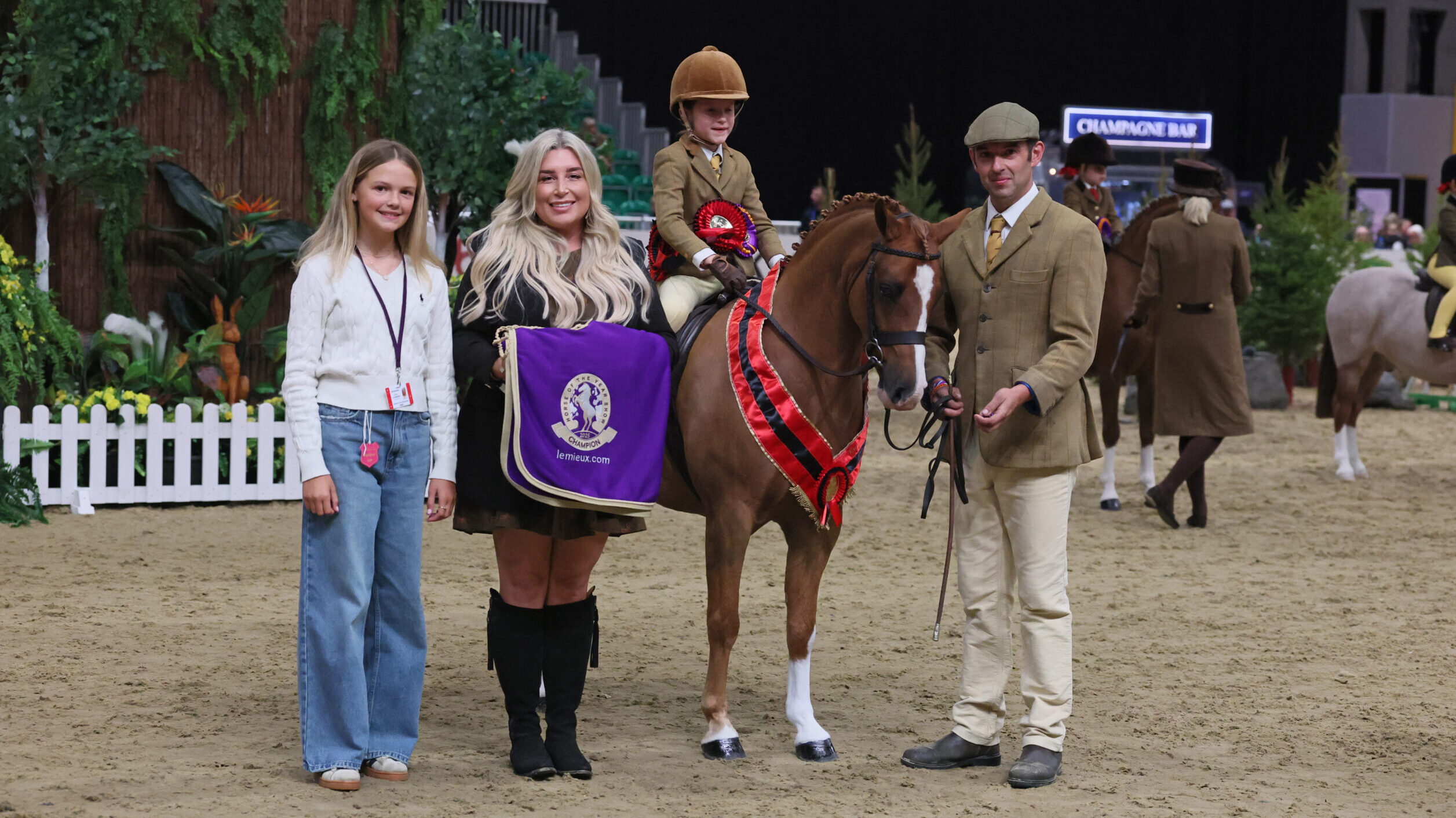 Isabel Burchell and Rowfantina Man Of The Match are lead by Oliver Burchell and presented with the lead-rein hunter pony champion title.