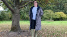 Lady wearing Hestt Eco-Ultra Riding Robe Front view with zip undone standing by a tree