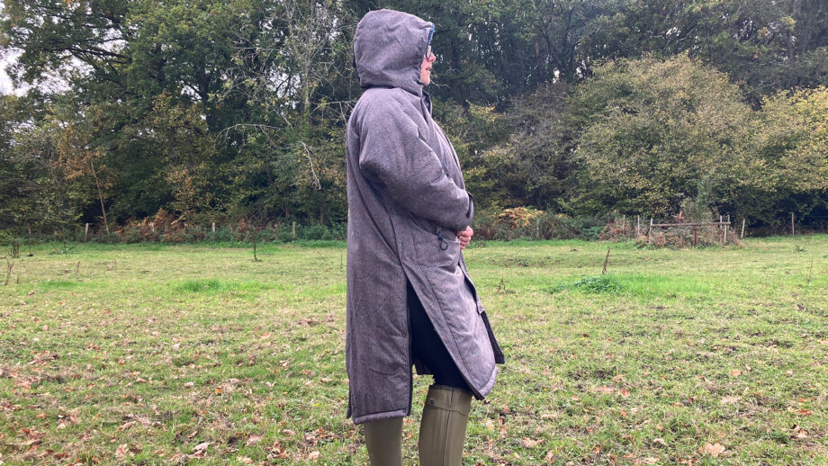 Lady wearing Hestt Eco-Ultra Riding Robe with hood up side view