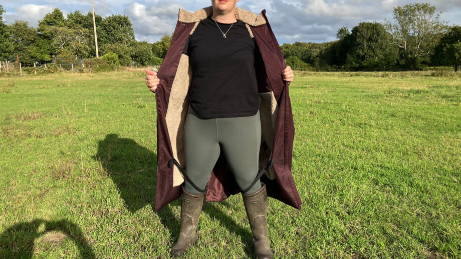 Lady wears LeMieux All Elements Robe in a field unzipped, viewed from the front