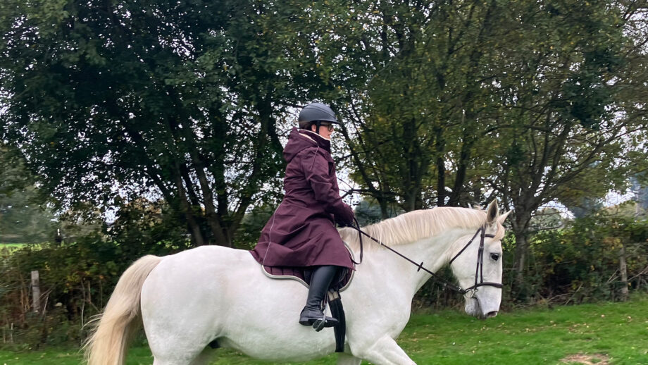 Rider wears LeMieux All Elements robe on horse, viewed from the side