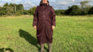 Lady wears LeMieux All Elements Robe in a field, viewed from the front