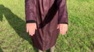 Lady wears LeMieux All Elements Robe in a field, showing close up of cuffs