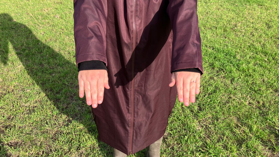 Lady wears LeMieux All Elements Robe in a field, showing close up of cuffs