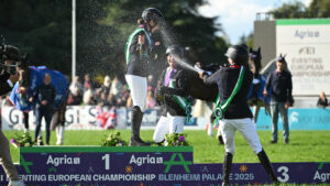 Laura Collett stands on the Blenheim Europeans podium while being sprayed with Champagne by Michael Jung and Tom McEwen.