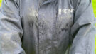 Lady wears Reincoat Lite, viewed from the front showing a close up of rain on material