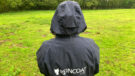 Lady wears Reincoat Lite, viewed from the Back showing a close up of rain on material