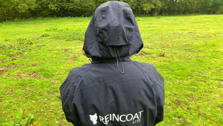 Lady wears Reincoat Lite, viewed from the Back showing a close up of rain on material