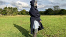 Lady wears Reincoat Lite, viewed from the side showing the reinshield