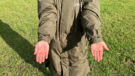 Lady wears Reincoat Pro in a field showing close up of cuffs