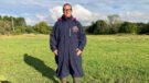 Lady wears Rydale Utility Changing Robe in a field, viewed from the front