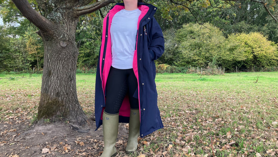 Lady wears Rydale Utility Changing Robe standing by a tree coat unzipped viewed from the front