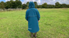 Lady wearing Two Bare Feet Hi-Vis Lightweight Riding Robe with hood up back view