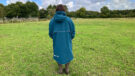 Lady wearing Two Bare Feet Hi-Vis Lightweight Riding Robe back view hood down