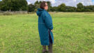 Lady wearing Two Bare Feet Hi-Vis Lightweight Riding Robe side view hood down