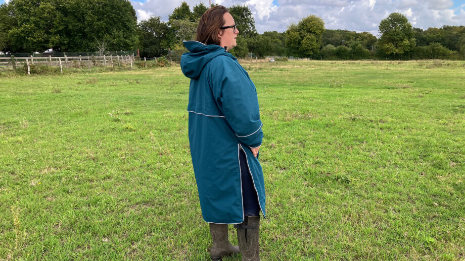 Lady wearing Two Bare Feet Hi-Vis Lightweight Riding Robe side view hood down