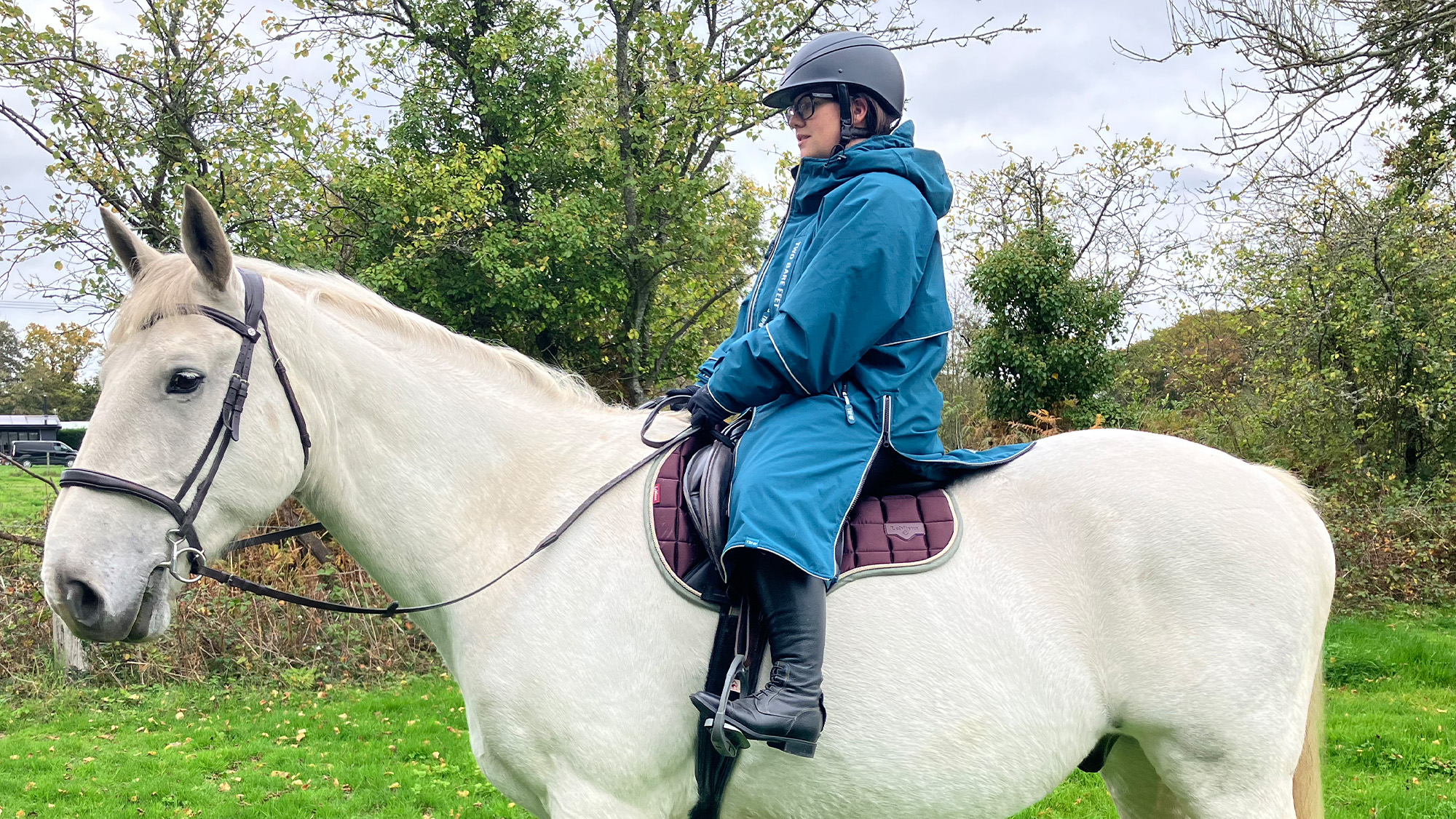 Rider wears Two Bare Feet Hi-Vis Lightweight Riding Robe on a horse, viewed from the side