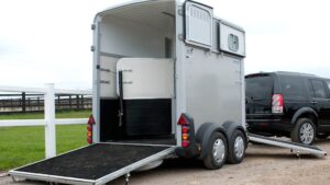 A horse trailer pictured from behind with the ramps down ready for loading.
