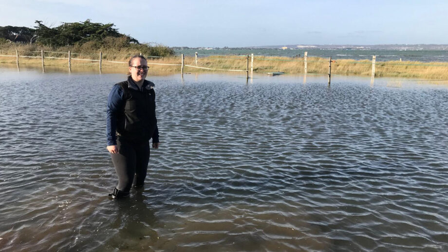 Fran wearing her aigle wellies wading through a high tide flood in her field