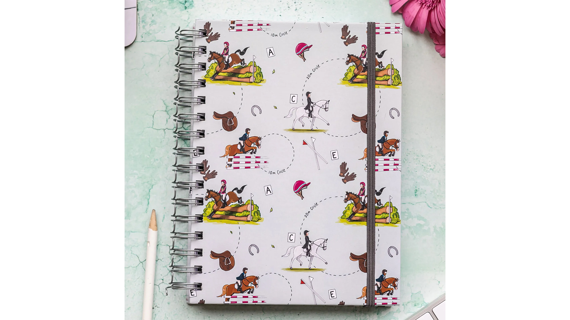 Notebook with an Emily Cole eventing design on the front 