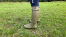 Side view of model wearing Le Chameau Chasseur Neoprene wellies in a field
