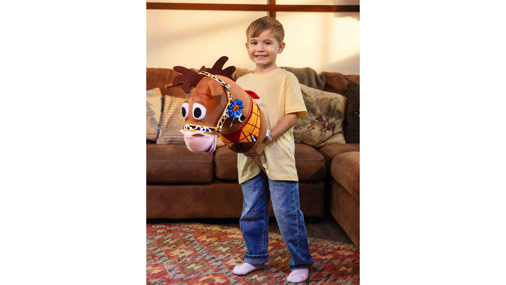 A boy riding a hobby horse 