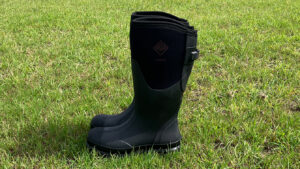 Side view of the Muck Boot Chore Adjustable Boots in a field
