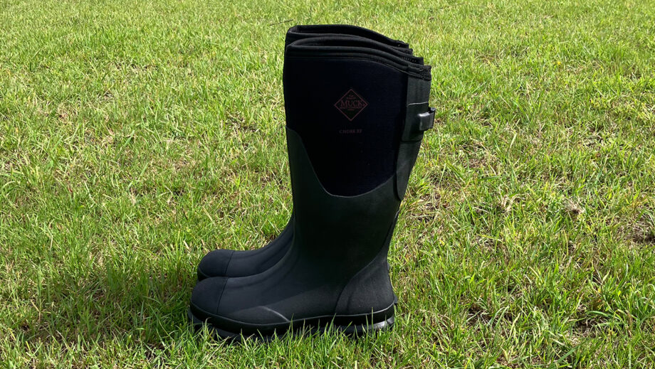 Side view of the Muck Boot Chore Adjustable Boots in a field