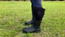 Close up side view of model wearing Chore wellies from the muck boot company