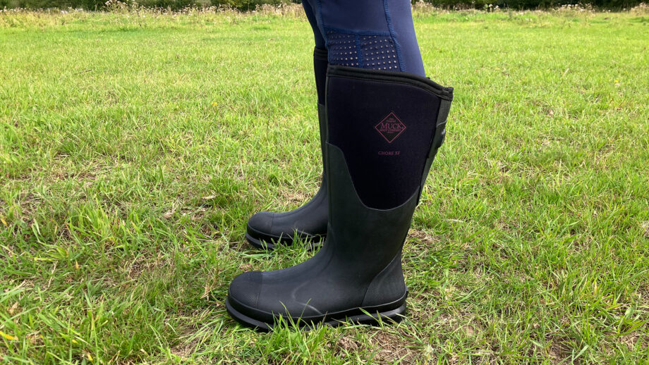 Close up side view of model wearing Chore wellies from the muck boot company