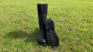 Muck Boot Women’s Chore Adjustable Tall Boots front view in field with one showing footbed