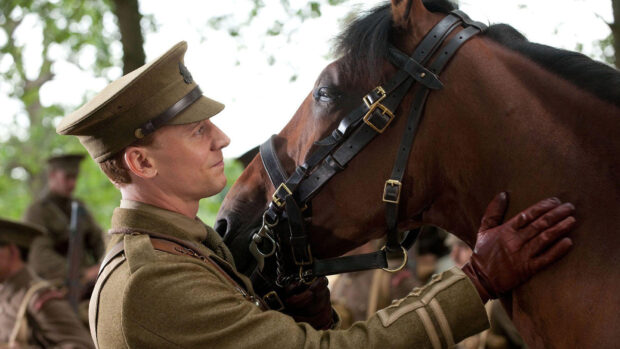 Still image from War Horse film, showing a horse with member of the army