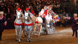 Father Christmas in his sleigh pulled by four white grey horses in the finale at the London International Horse Show in 2004