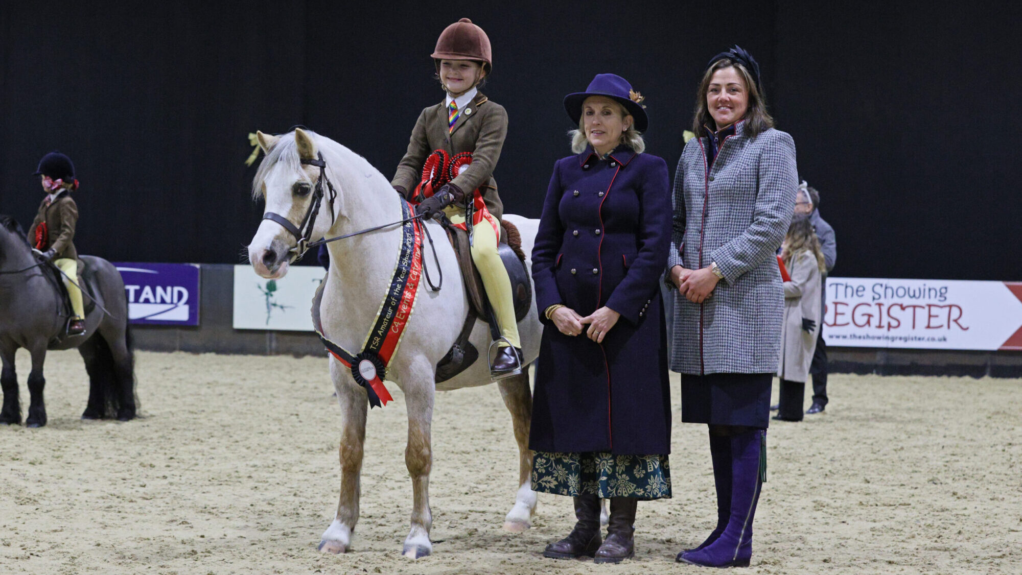 Waitwith Lady Jayne and Neive Chapplehow-Lacey win the mountain and moorland first ridden division and stand for a photo with judges Michaela Bowling and Lizzie Briant