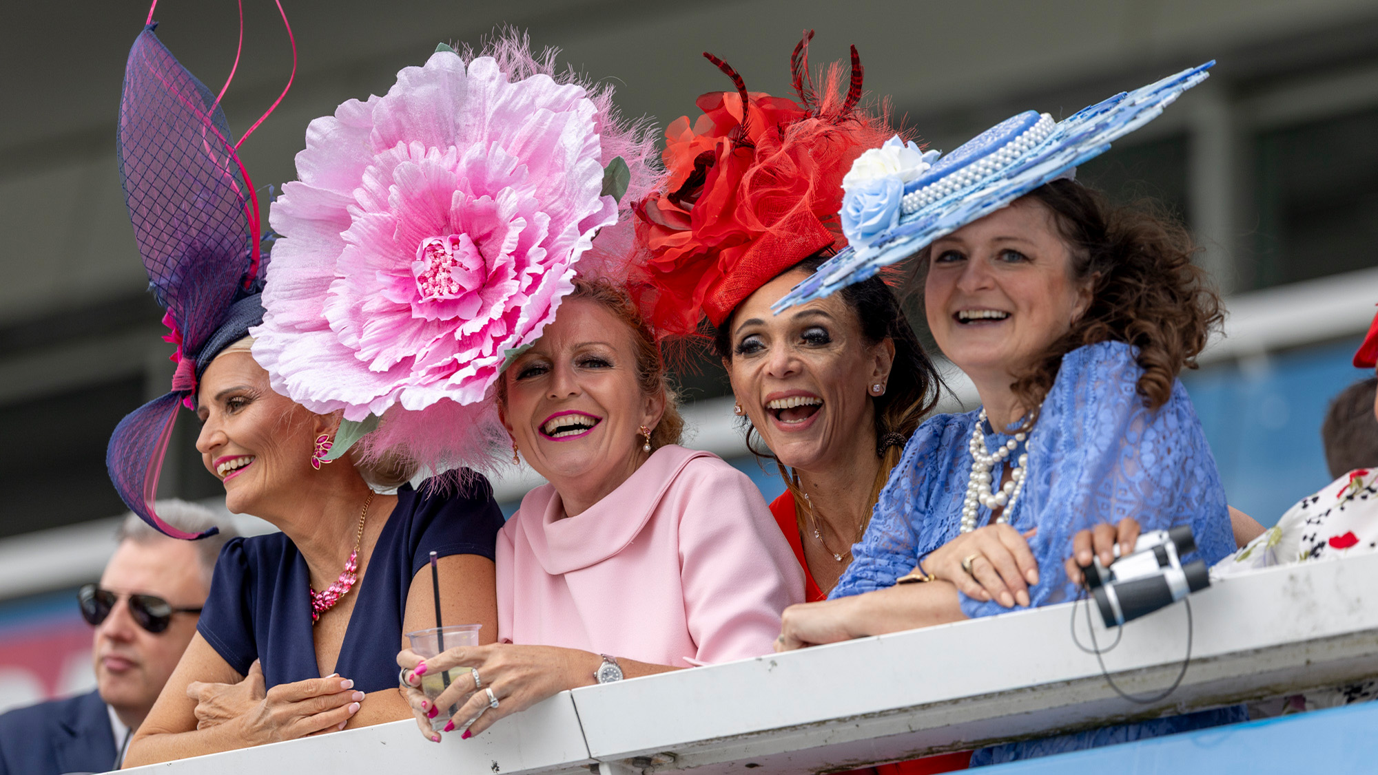 Four ladies watching racing on Ladies Day at the Epsom Derby Festival