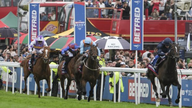 Image shows the action at the 2025 Derby. Winner Lambourn leads the field home in front of the crowds.