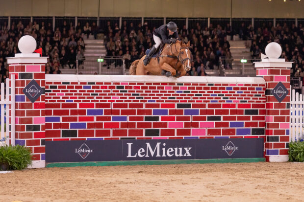 Andrew Hodgins and Shanaclough Luichew soaring into equal third in the puissance at the London International Horse Show 2025.