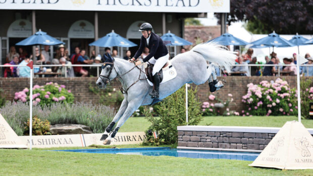 Matt Sampson jumps grey horse Daniel over the open water fence during the King George Gold Cup at Hickstead.