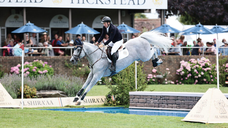 Matt Sampson jumps grey horse Daniel over the open water fence during the King George Gold Cup at Hickstead.