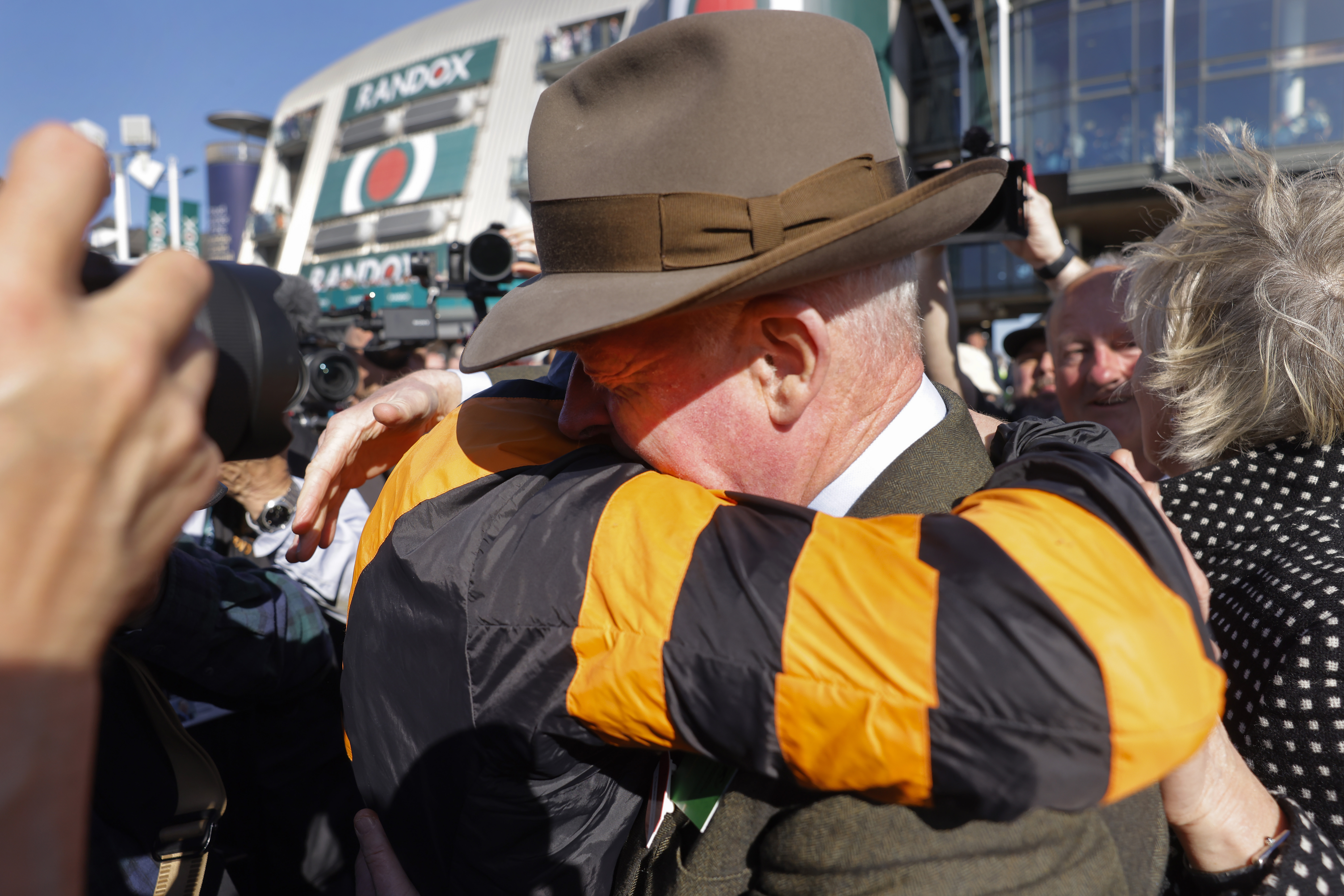 Willie Mullins and his son Patrick embrace after winning the Grand National at Aintree in 2025.