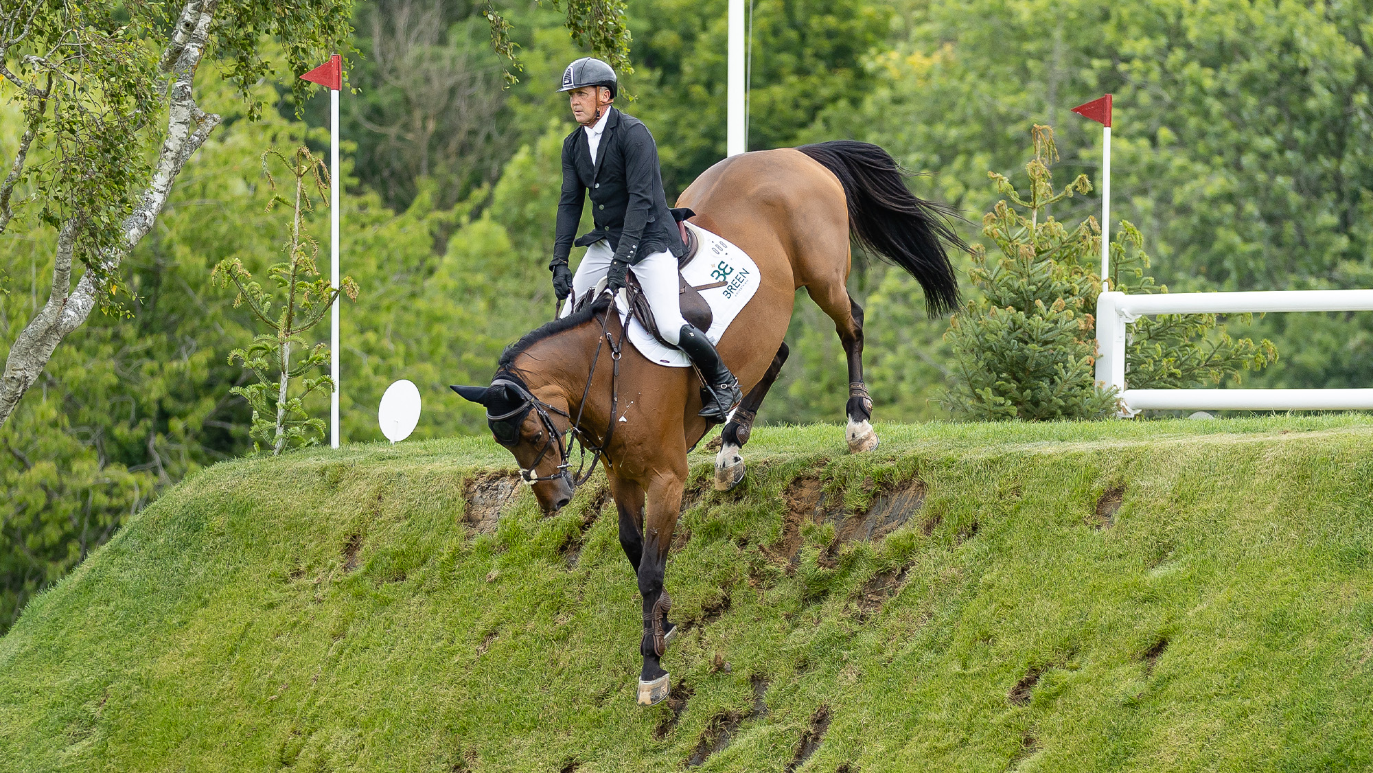 Shane Breen rides Fanfan de Beaufour down the Hickstead Derby Bank