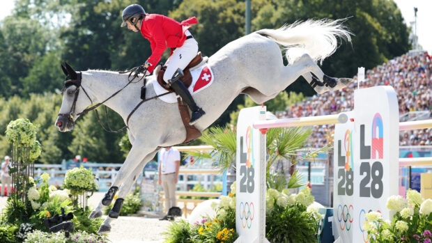 Martin Fuchs jumps the LA28 fence at the Paris Olympics