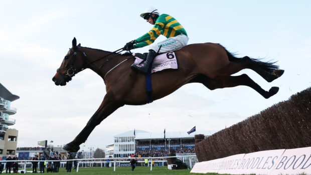 Mark Walsh riding Inothewayurthinkin clears the last fence on the way to winning the Boodles Gold Cup Chase at the Cheltenham Festival