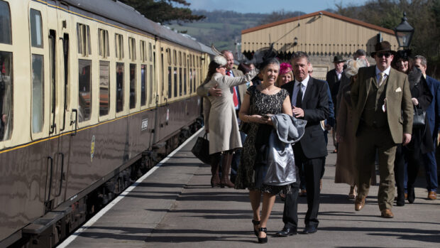 Racegoers arriving at Cheltenham racecourse on steam train platform