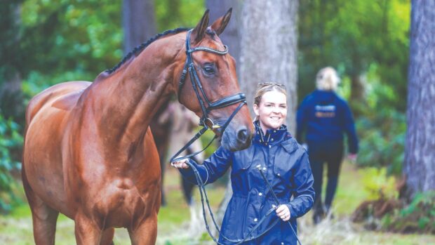 Groom Rachel Owens leading a horse at Osberton International Horse Trials