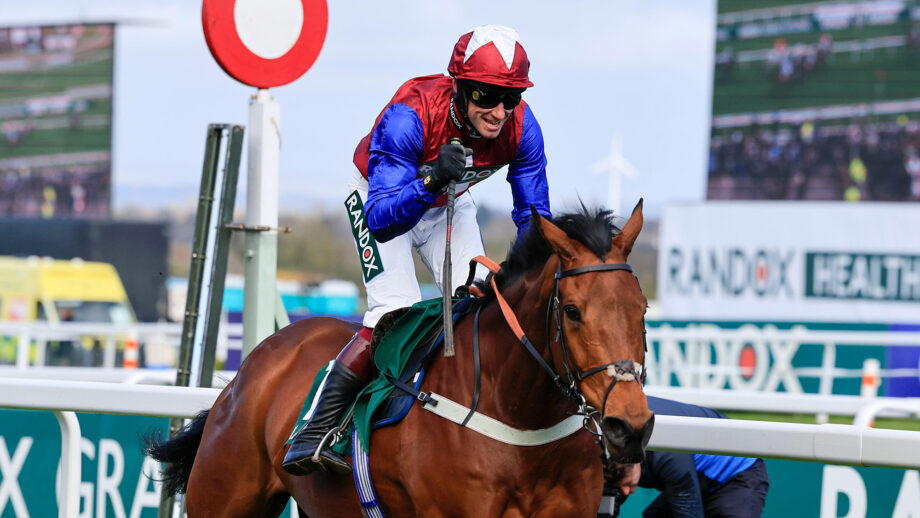 Will Biddick punches the air after passing the Aintree winning post on board Famous Clermont.