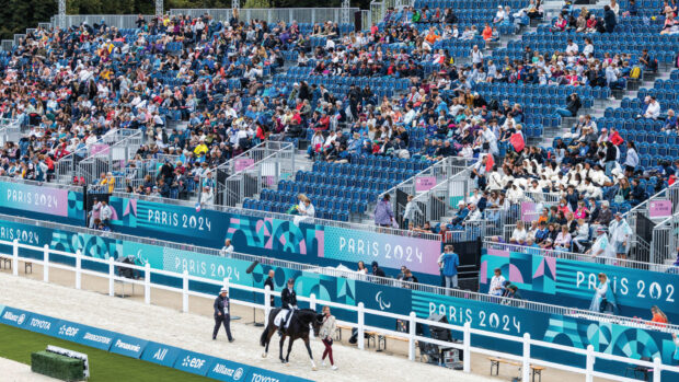 Pictured a horse and para dressage rider walking round the arena at the Paris Paralympic Games in 2024.