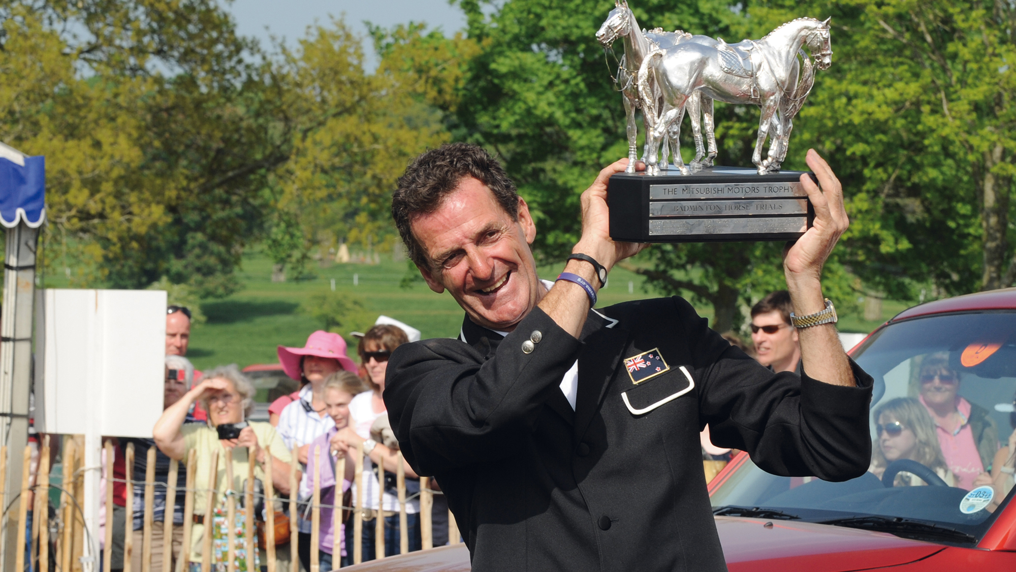 Mark Todd raises the Badminton Horse Trials trophy after his 2011 triumph. 