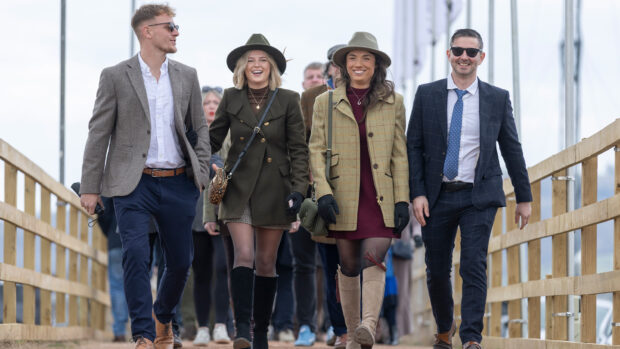 Two men and two ladies dressed for the races arrive at Cheltenham